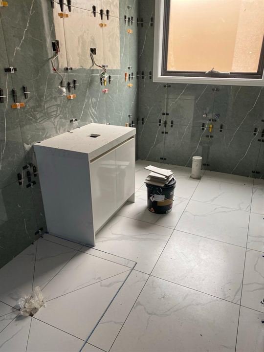 Bathroom wall and floor tiling in progress