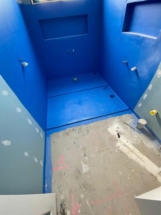 Blue waterproofing membrane applied to a shower recess